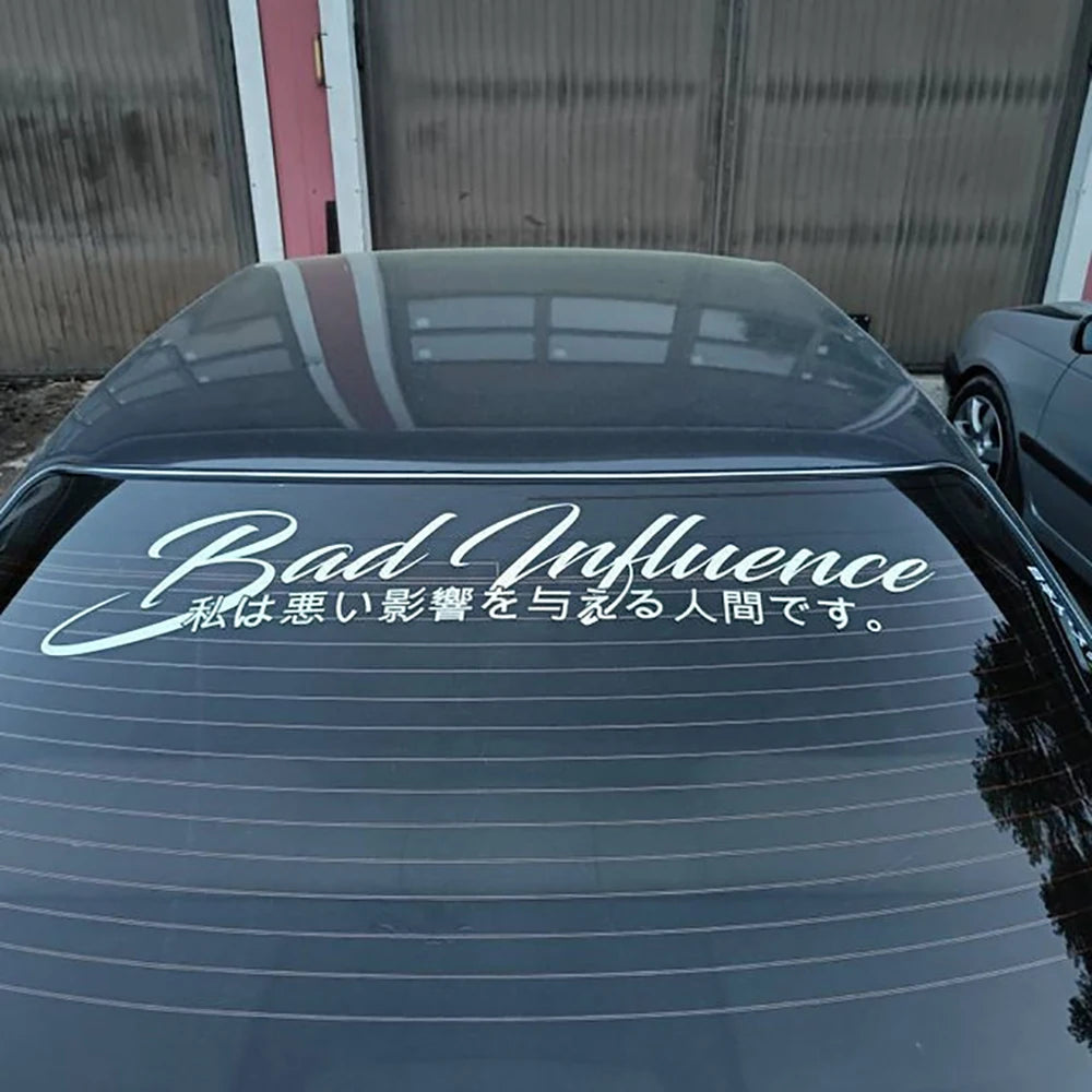 Bad Influence windshield sticker with Japanese text displayed on a red modified sports car
