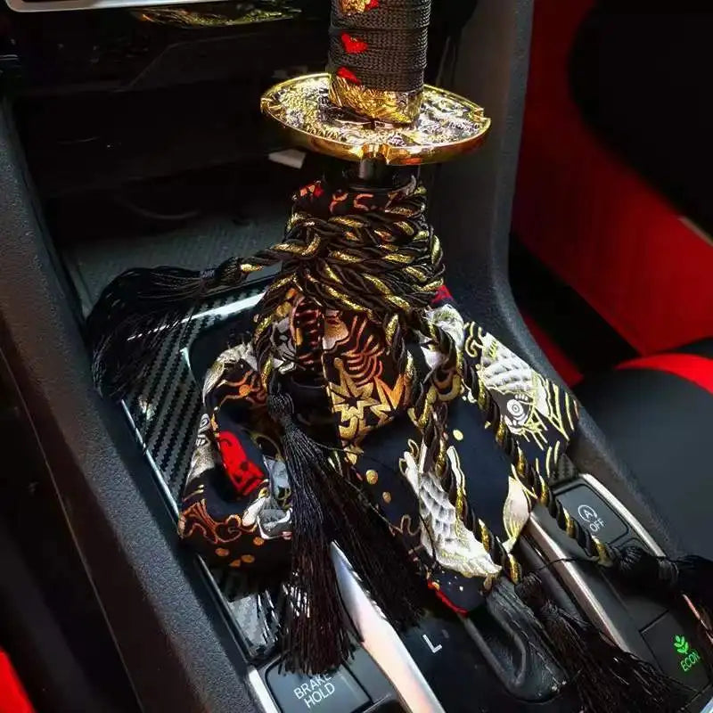 Samurai katana style manual shift knob with wrapped black and red grip installed in a car interior