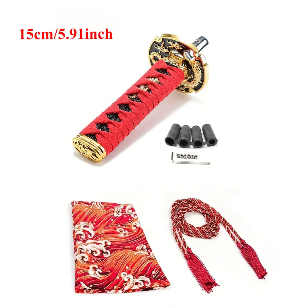 Samurai katana style manual shift knob with wrapped black and red grip installed in a car interior