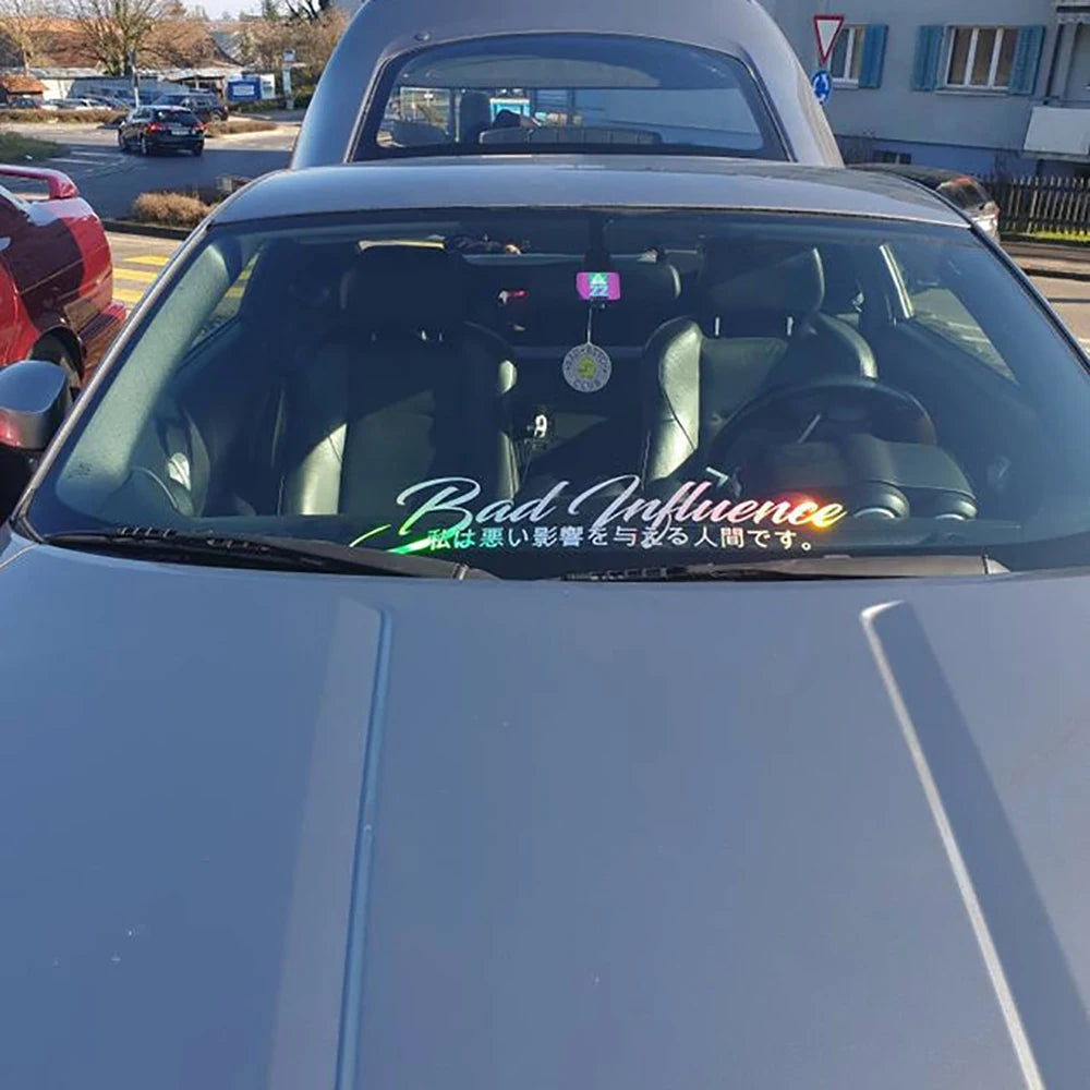 Bad Influence windshield sticker with Japanese text displayed on a red modified sports car