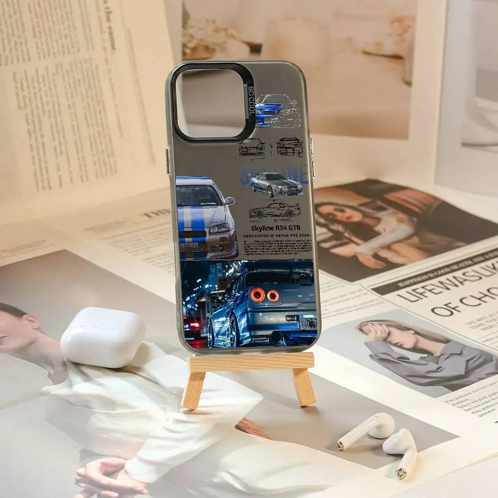 Nissan Skyline R34 phone cases featuring blue and purple JDM car artwork, technical illustrations, and automotive photography