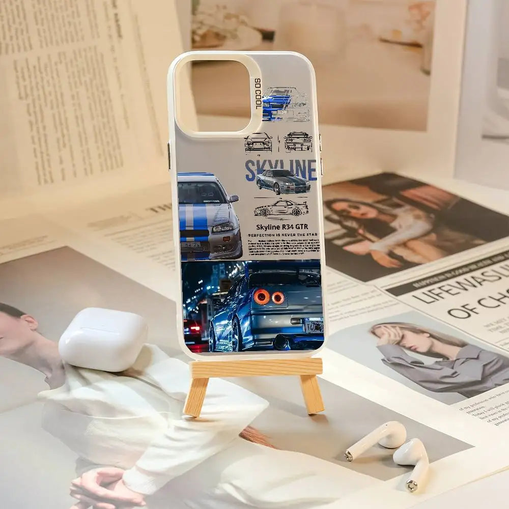 Nissan Skyline R34 phone cases featuring blue and purple JDM car artwork, technical illustrations, and automotive photography
